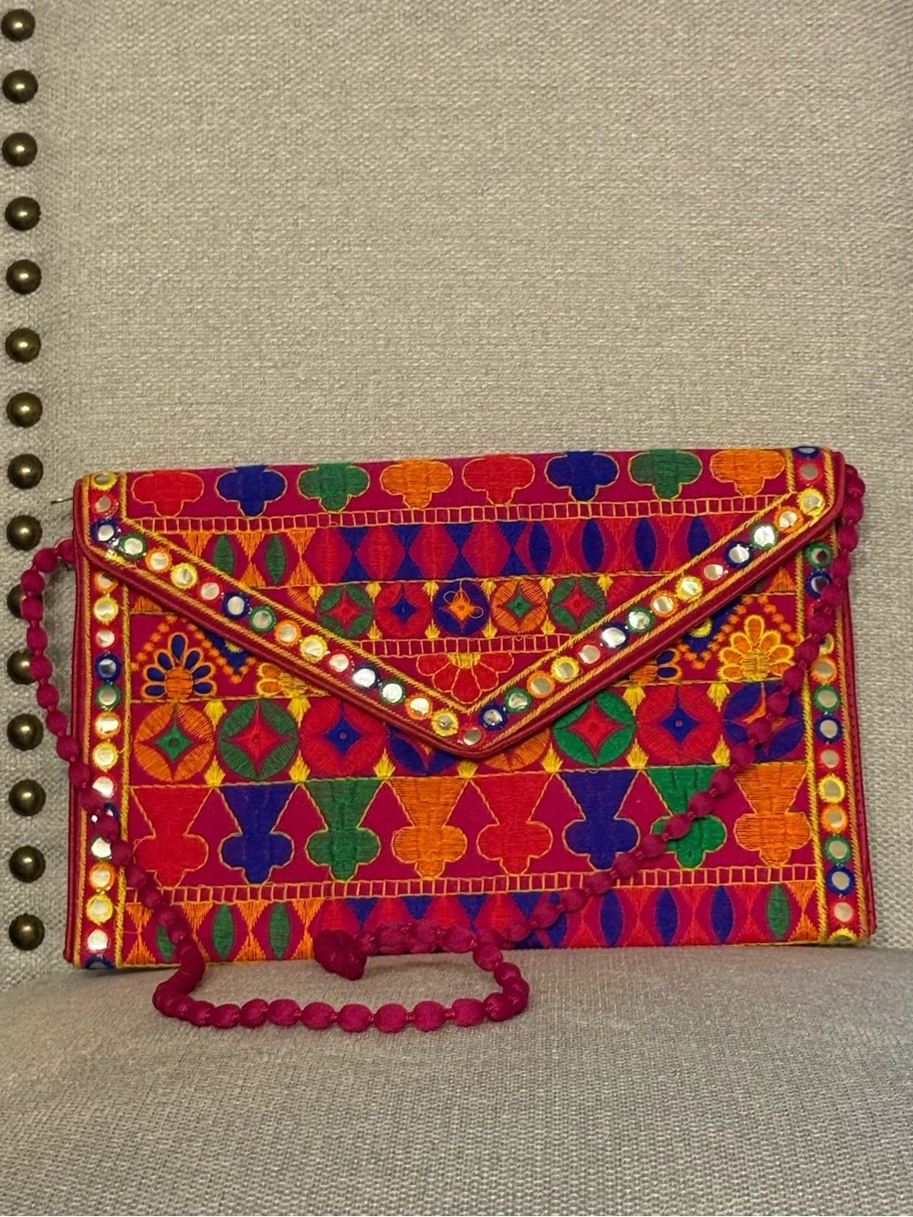 Multicolor Embroidered Fold-Over Clutch with Pom-Pom Strap